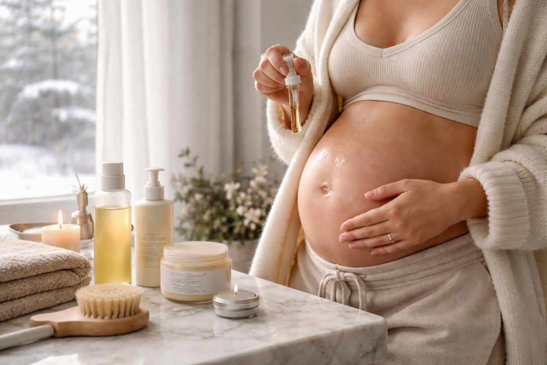 Pregnant woman applying belly oil in winter