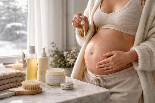 Pregnant woman applying belly oil in winter