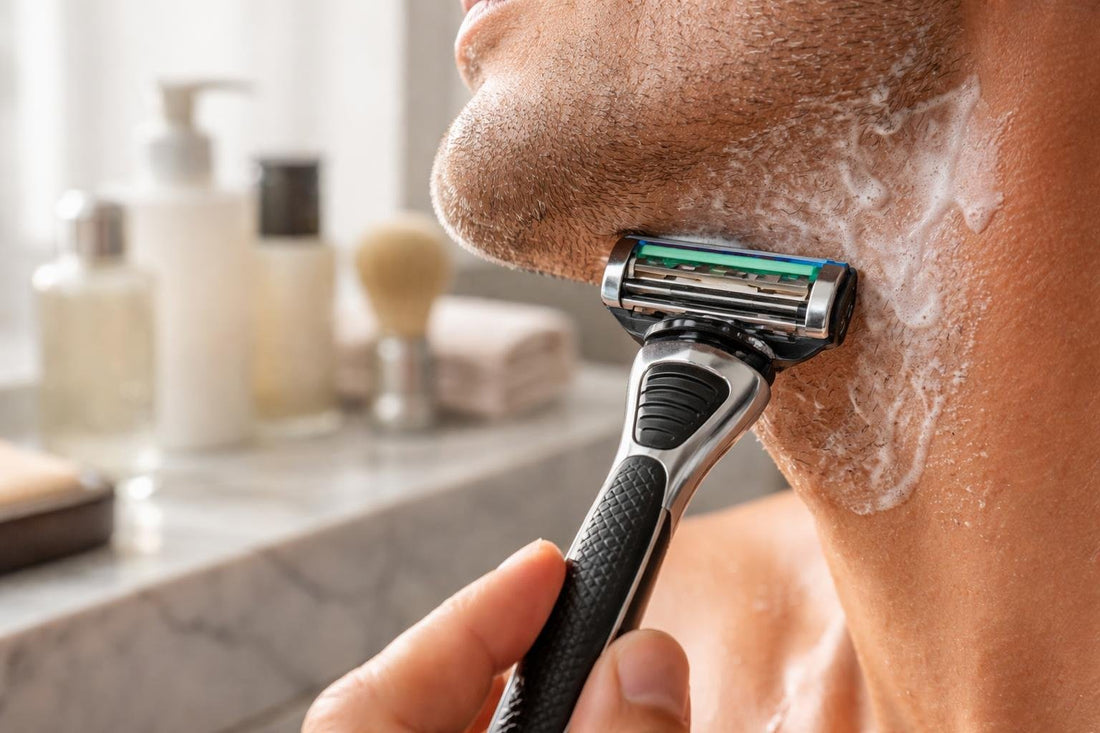 Close-up cartridge razor on wet skin