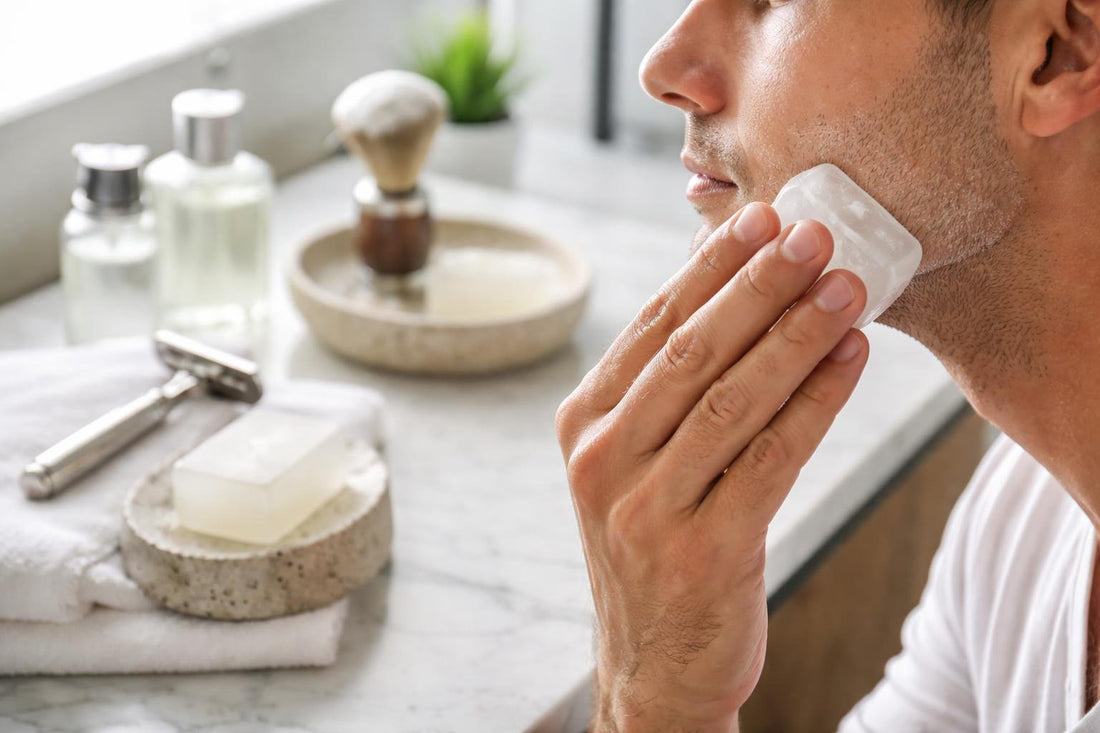 Hands applying alum block after a wet shave