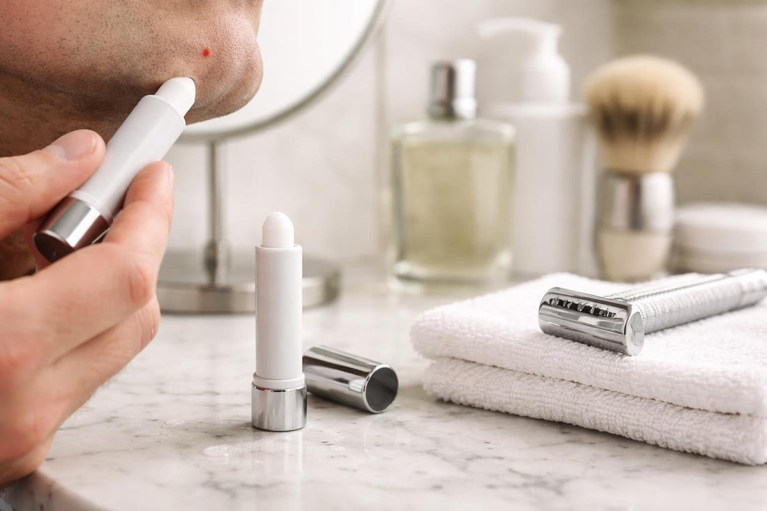 Styptic pencil stopping a small shaving nick on skin