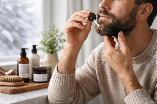 Man applying beard oil in winter for dryness relief