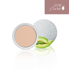 Applying 100% PURE Cream Foundation Concealer for seamless coverage.