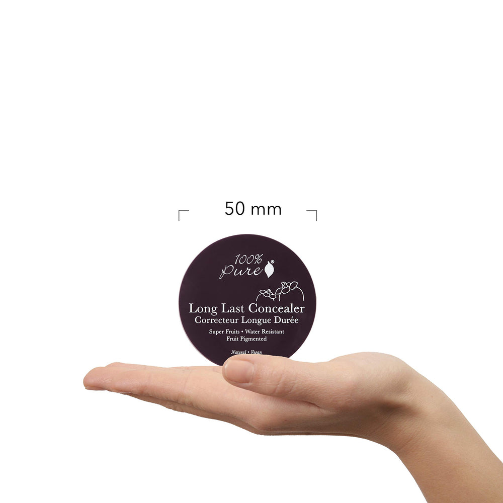 100% PURE concealer compact in hand for on-the-go touch-ups