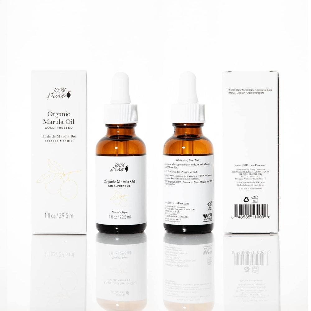 Closeup of 100% PURE Marula Oil label highlighting vegan, cold-pressed purity for radiant skin