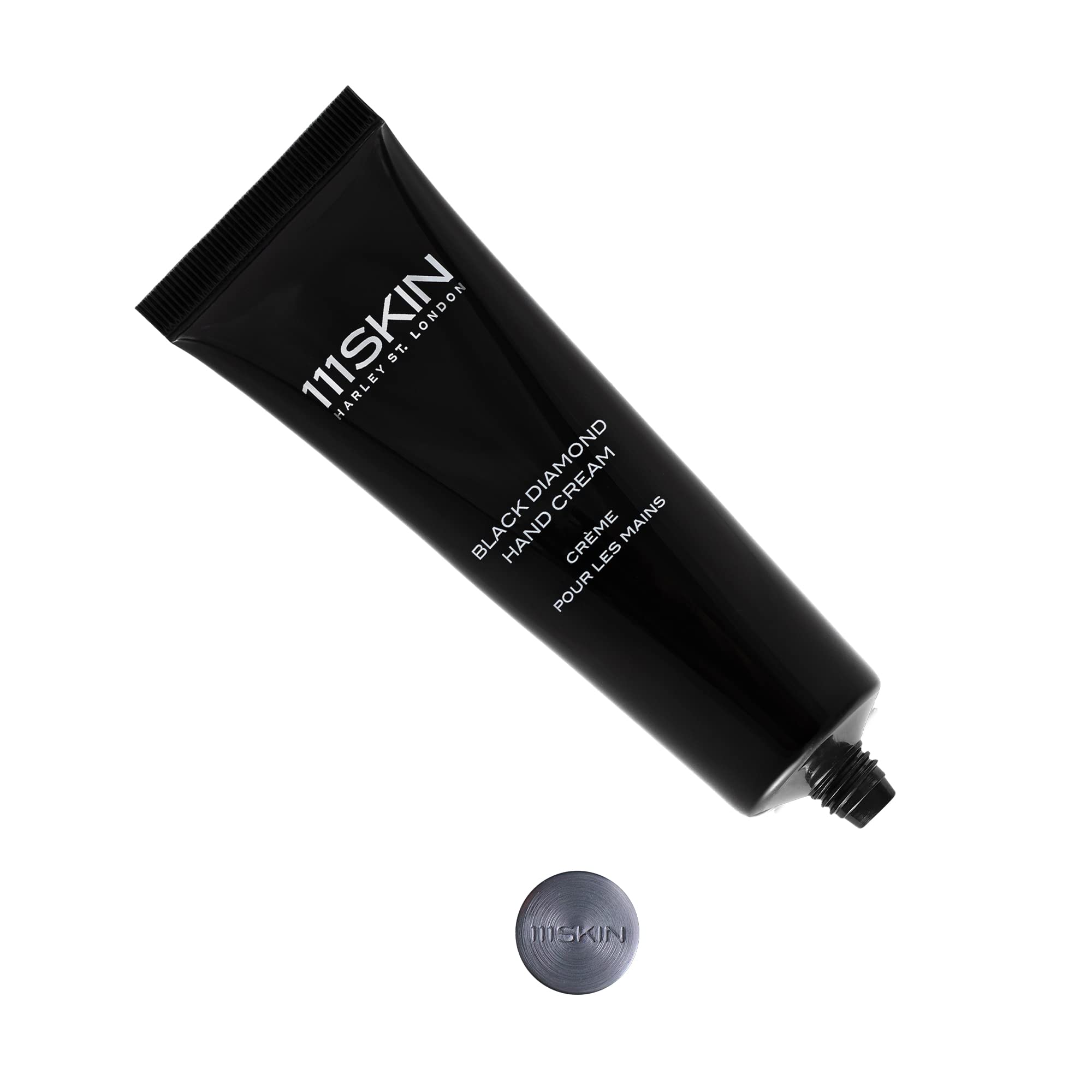 Applying 111SKIN Celestial Black Diamond Hand Cream to nourish hands.