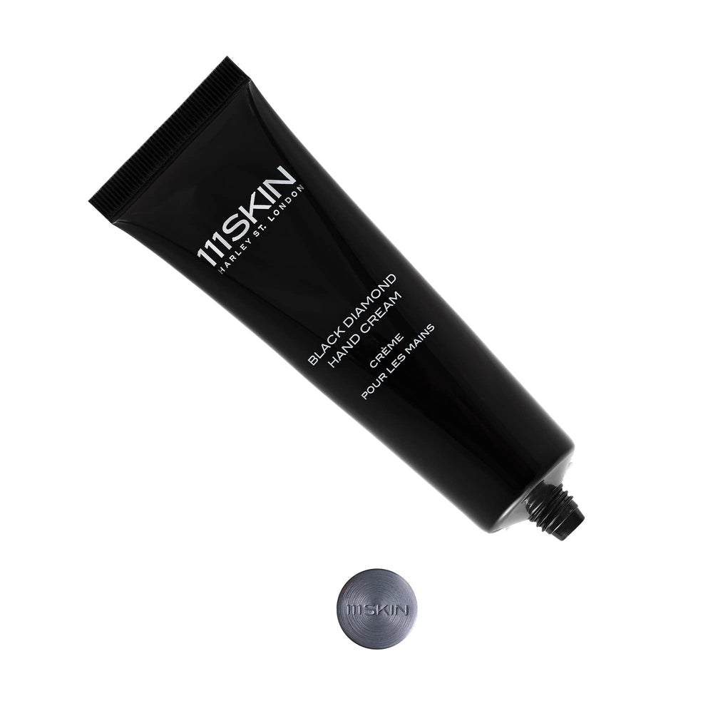 Applying 111SKIN Celestial Black Diamond Hand Cream to nourish hands.