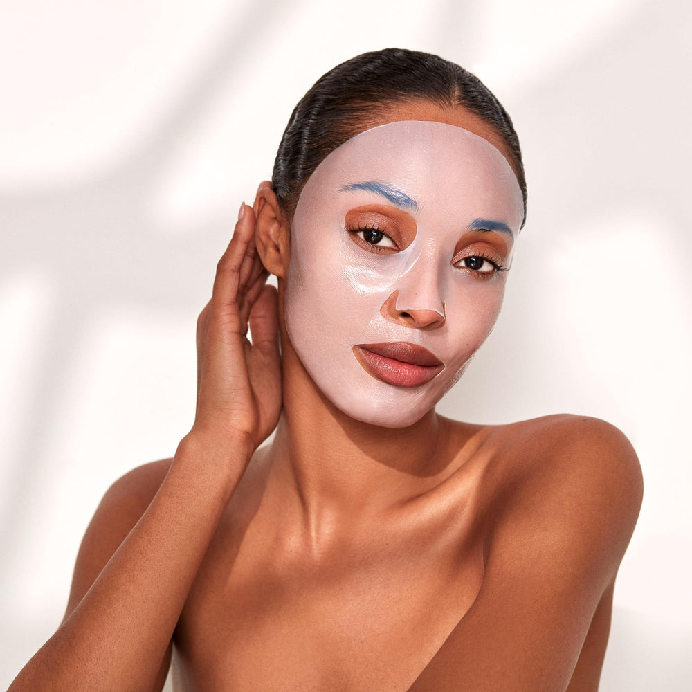 Layered masks illustrate a multi-action at-home skincare ritual.