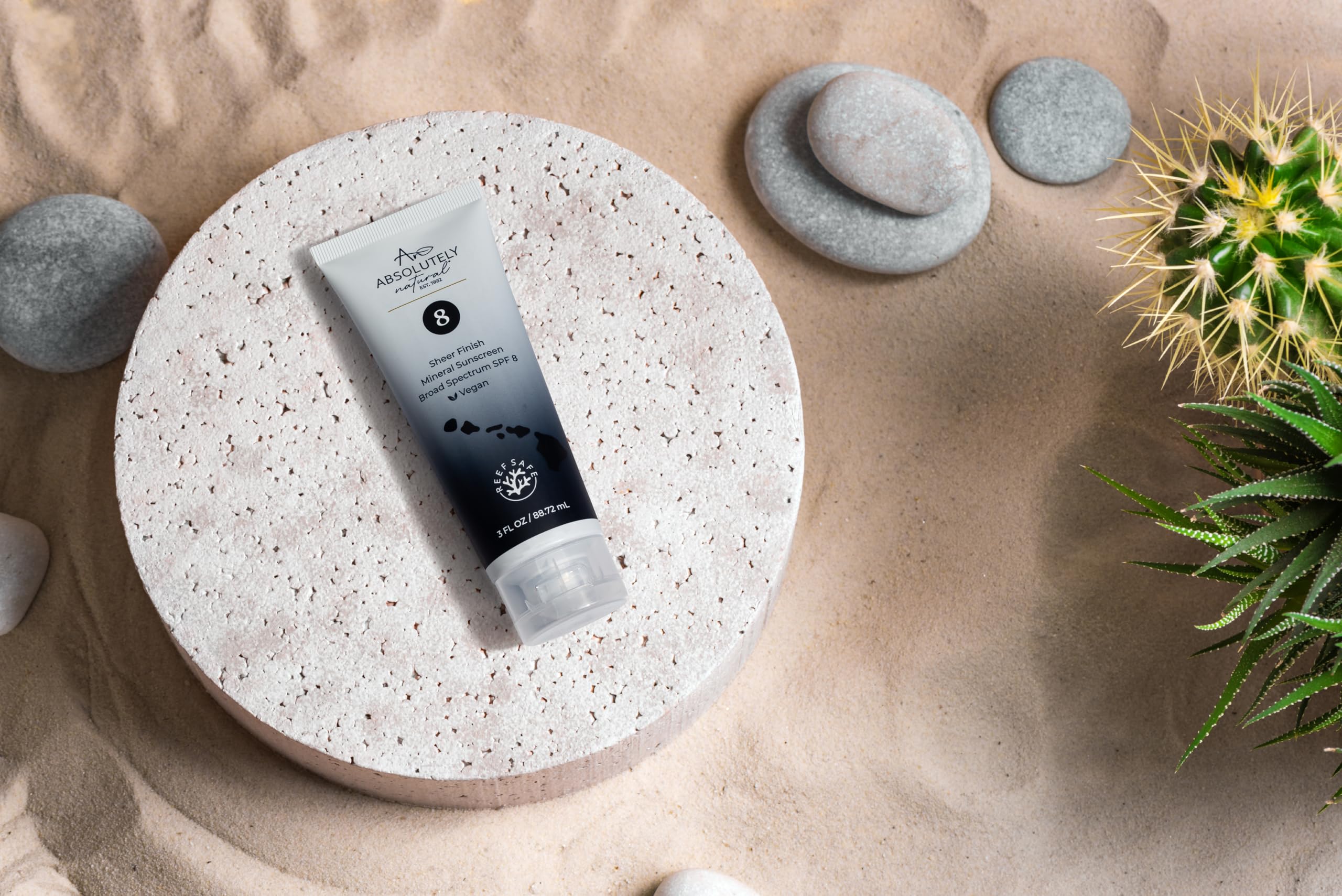 Absolutely Natural SPF 8 bottle outdoors in sunlight.