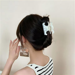 Acetate butterfly clip in tortoiseshell brown coordinates with neutral outfits