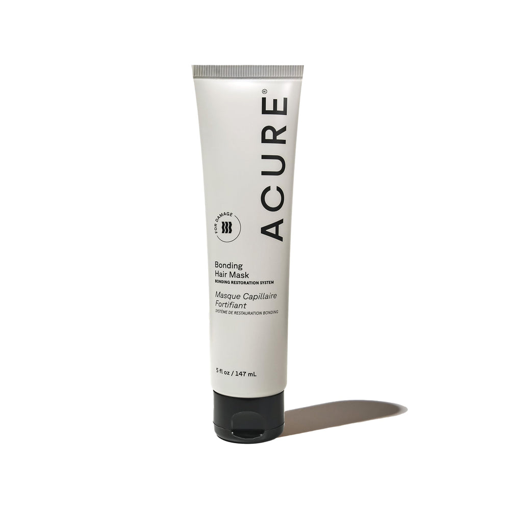 Acure Bonding Hair Mask jar on sink, convenient weekly conditioning for damaged hair.