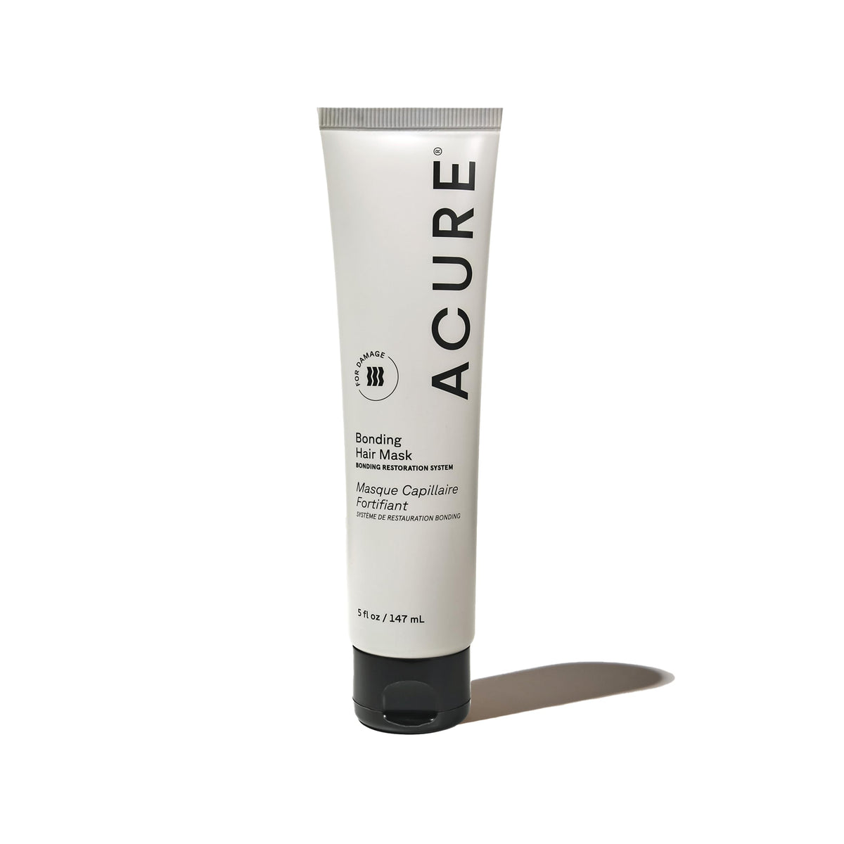 Acure Bonding Hair Mask jar on sink, convenient weekly conditioning for damaged hair.