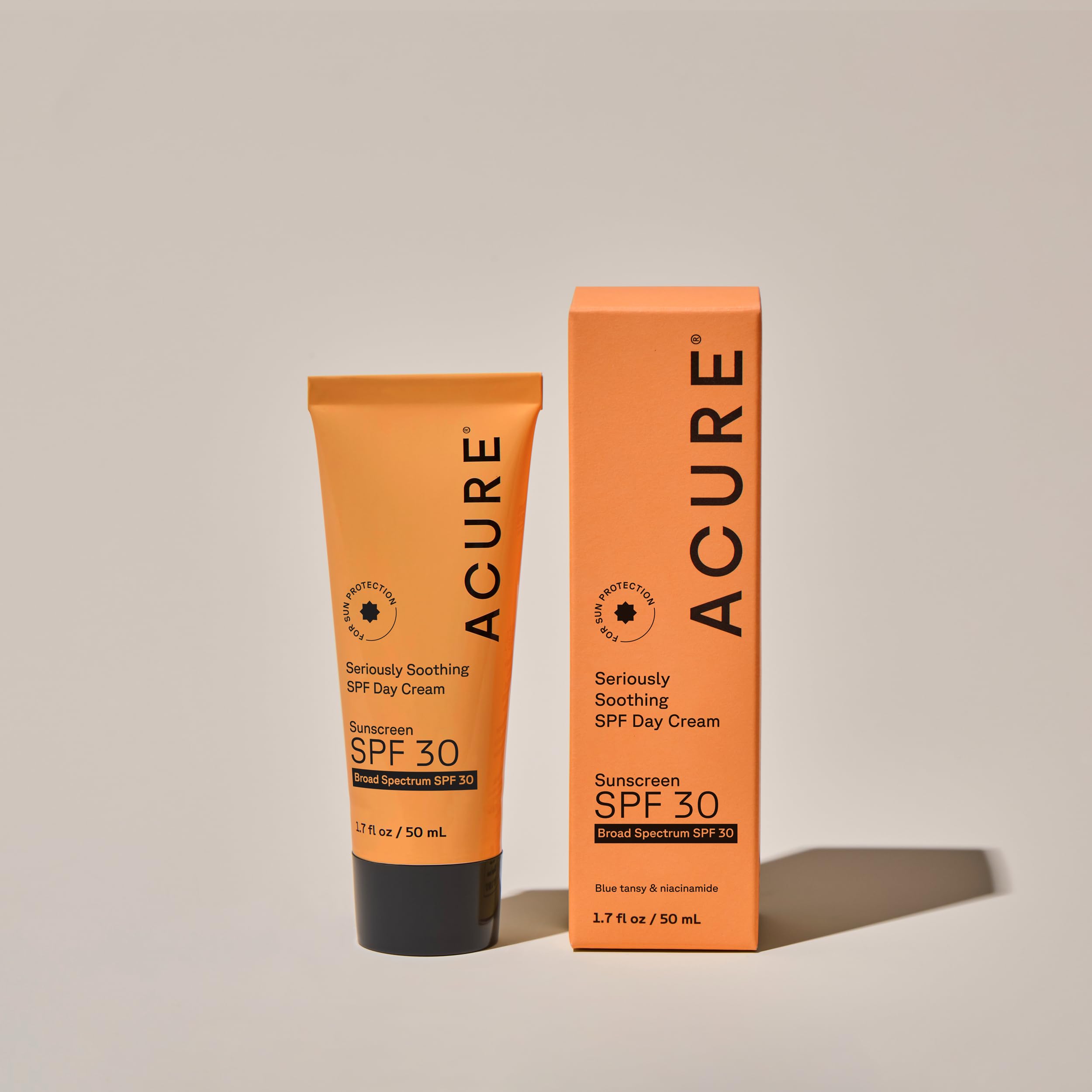 Acure SPF 30 cream on face highlights Niacinamide and Blue Tansy for calm care.