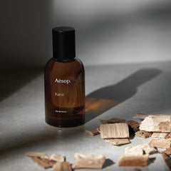 Aesop Karst bottle on wood background complements earthy sandalwood notes