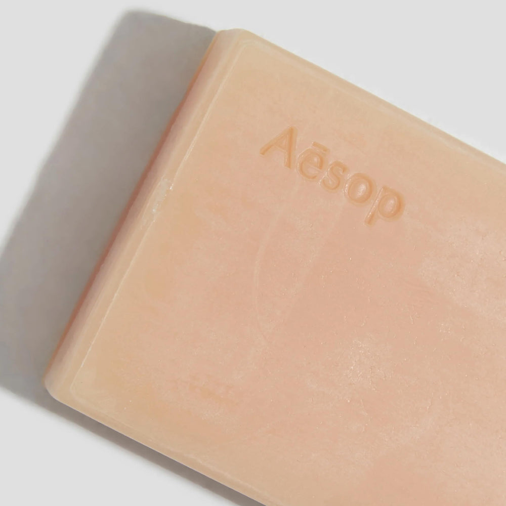 Aesop Nurture Bar Soap with shea butter nourishing the skin during wash.