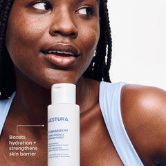 Hands applying Aestura hydro essence during daily skincare routine