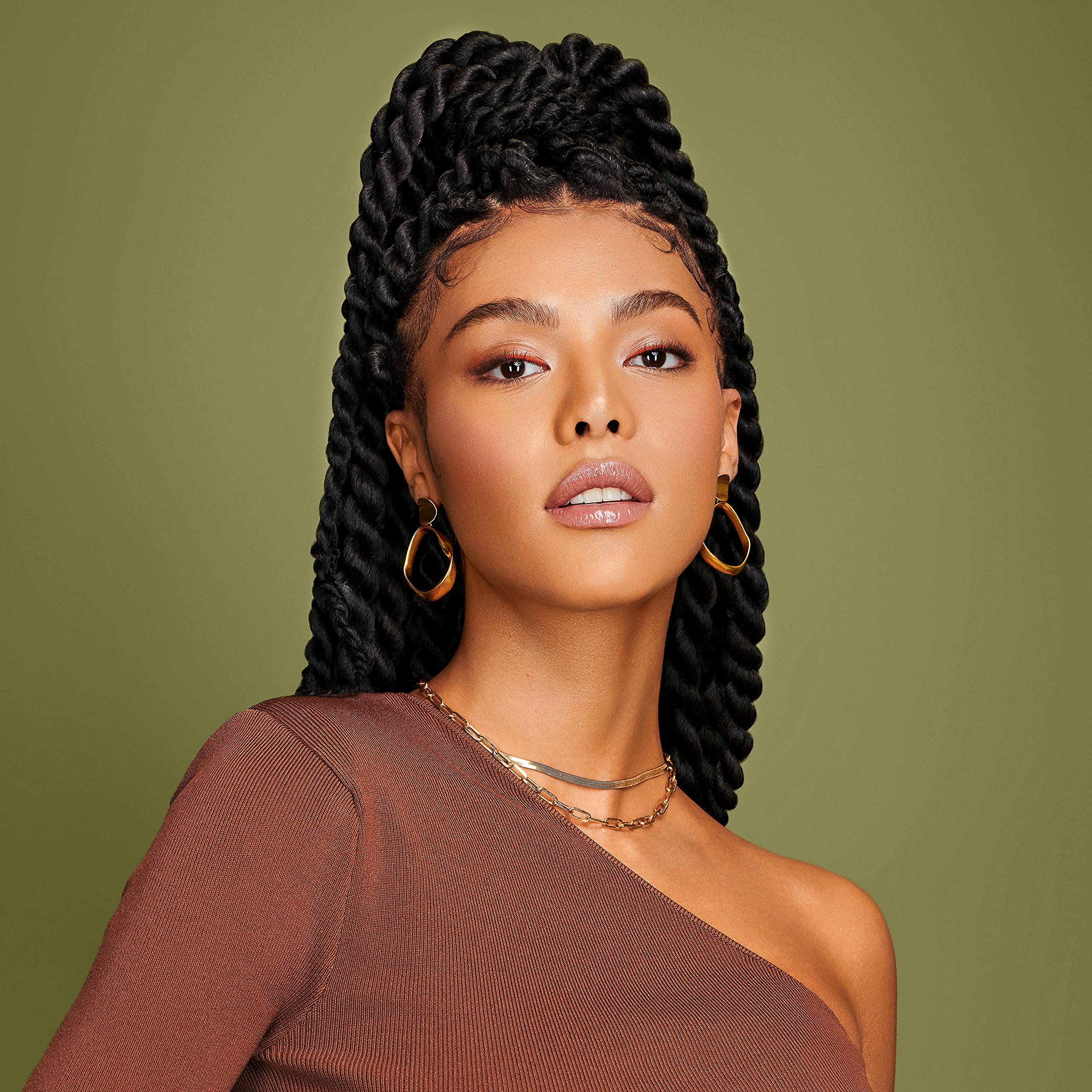 Bottle on wood backdrop conveys natural, moisture-rich hair care ritual.