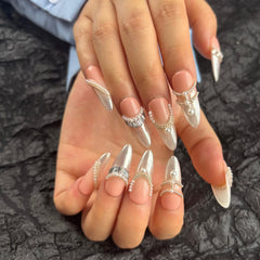 AKA Unicorn nails featuring Aurora silver and nude pink base with pearl accents for chic style.