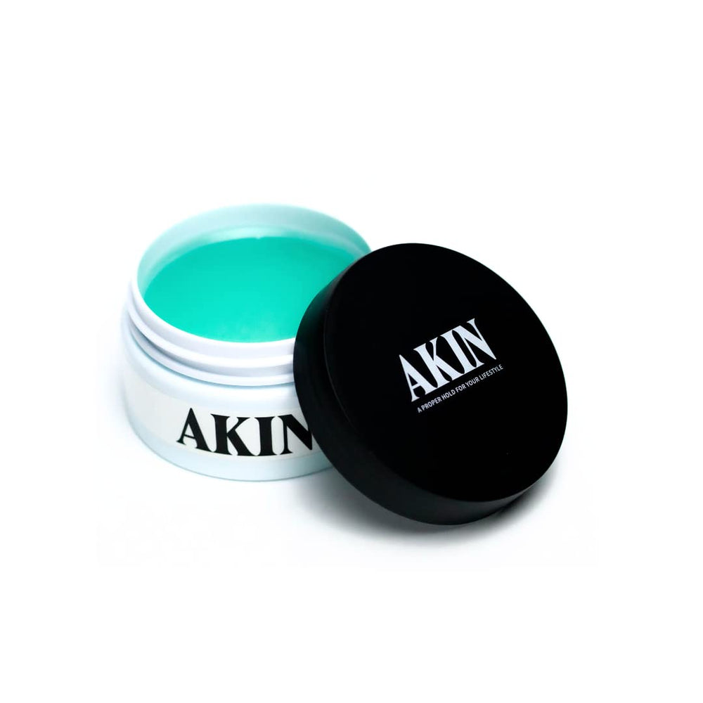 AKIN Official Pomade packaging showing the travel-friendly jar for on-the-go styling