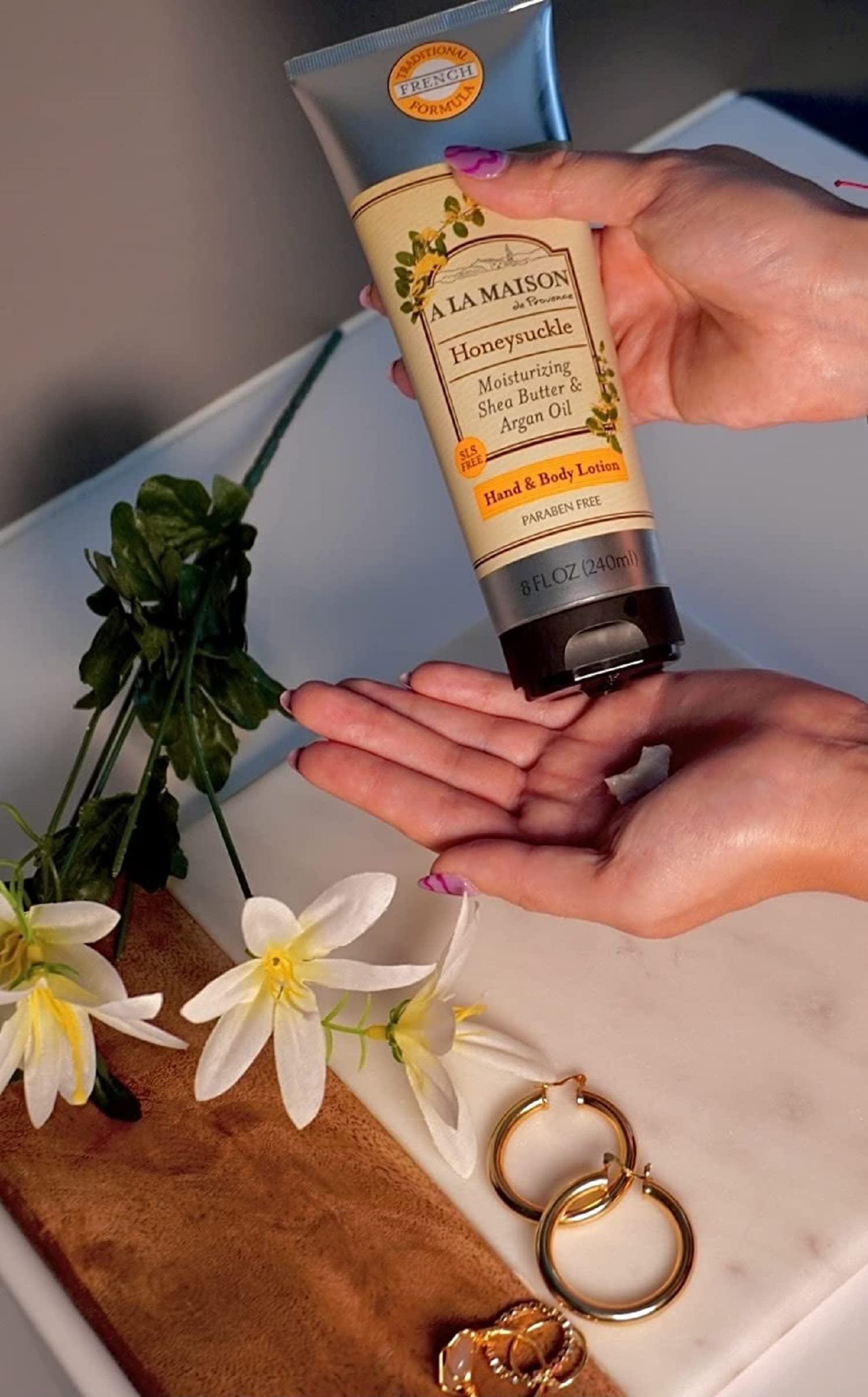 A LA MAISON honeysuckle lotion texture close-up shows non-greasy hydration.