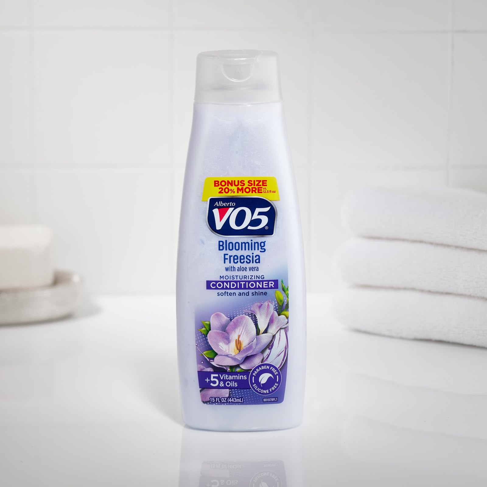 Close-up of the product label highlighting five oils and vitamins for hair health