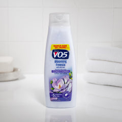 Close-up of the product label highlighting five oils and vitamins for hair health
