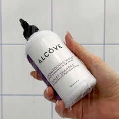 Alcove anti-frizz shine close-up demonstrates sleek, polished hair.