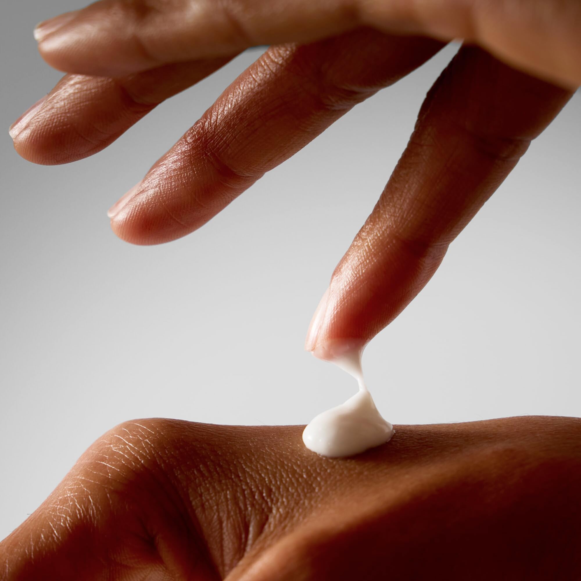 ALO Superfruit pump bottle dispensing lotion into hand