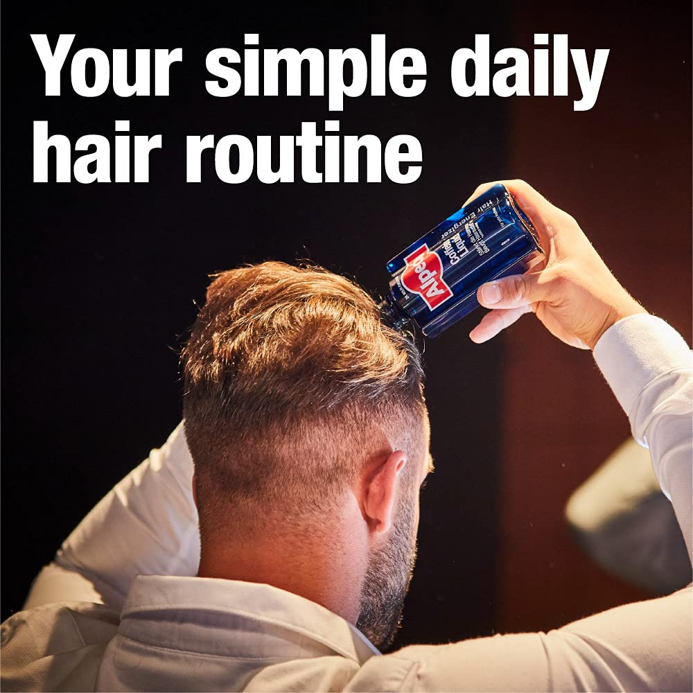Hand applying energizer for targeted caffeine boost to hair roots.