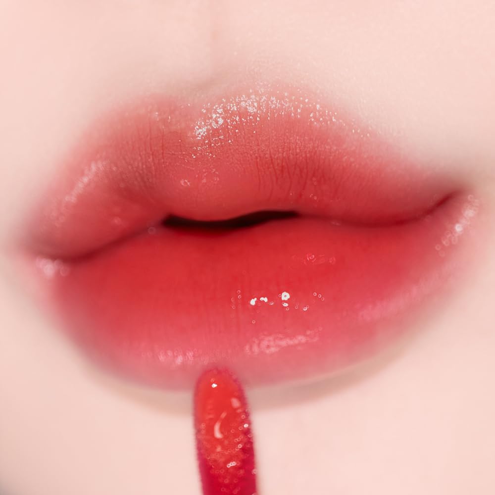 alternativestereo Lip Potion Aqua Glow Apple Drop lip swatch shows vibrant red tint for everyday glam.