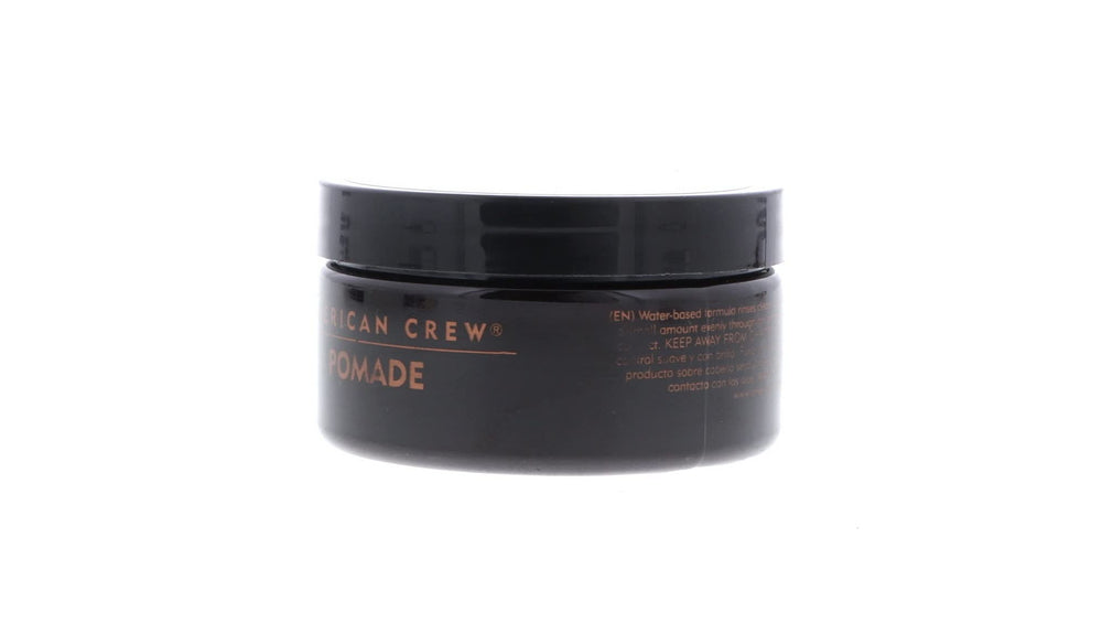 Model showcasing polished hair with American Crew Pomade's shine.