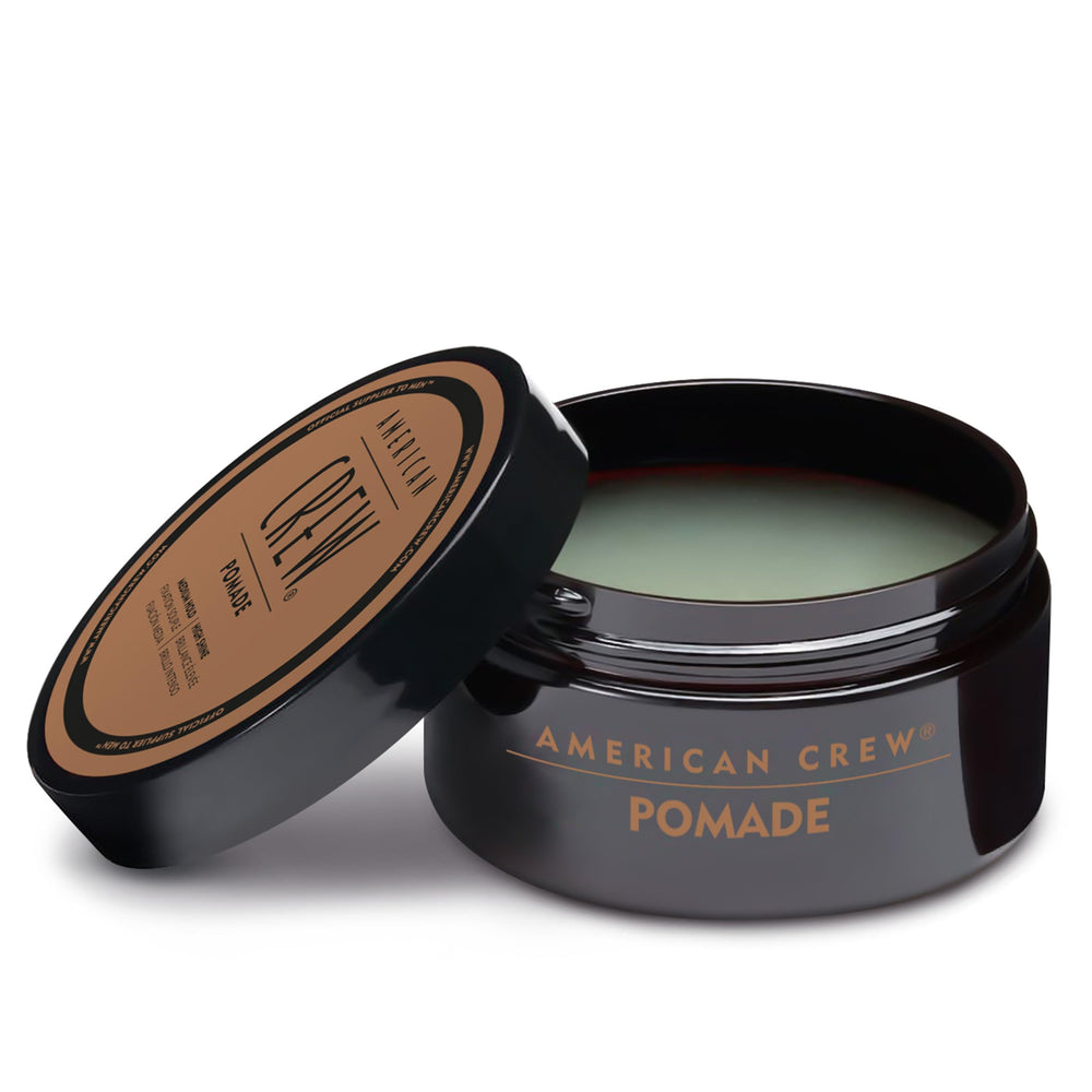 American Crew pomade packaging detail suggesting travel-friendly design