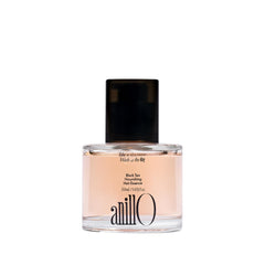 ANILLO Black Tea Nourishing Hair Essence bottle highlights lightweight formula for silky shine