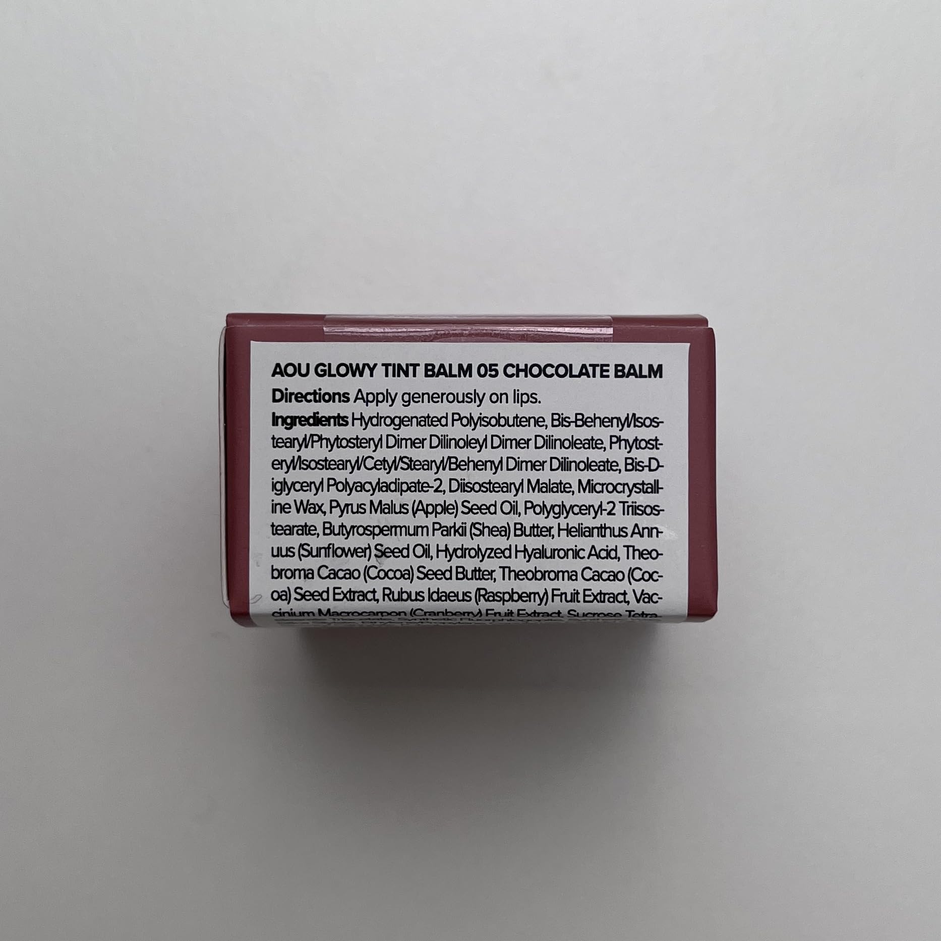 AOU Glowy Tint Balm melts onto lips delivering instant hydration.