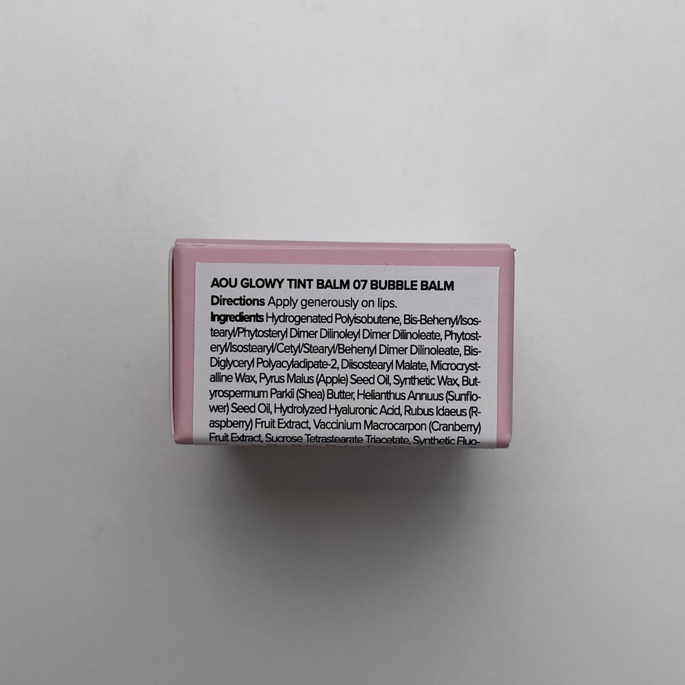 AOU Glowy Tint Balm tube held for travel-friendly use