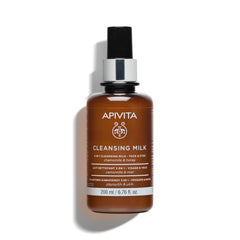 Apivita cleansing milk bottle closeup; velvety formula for makeup removal and gentle cleansing.