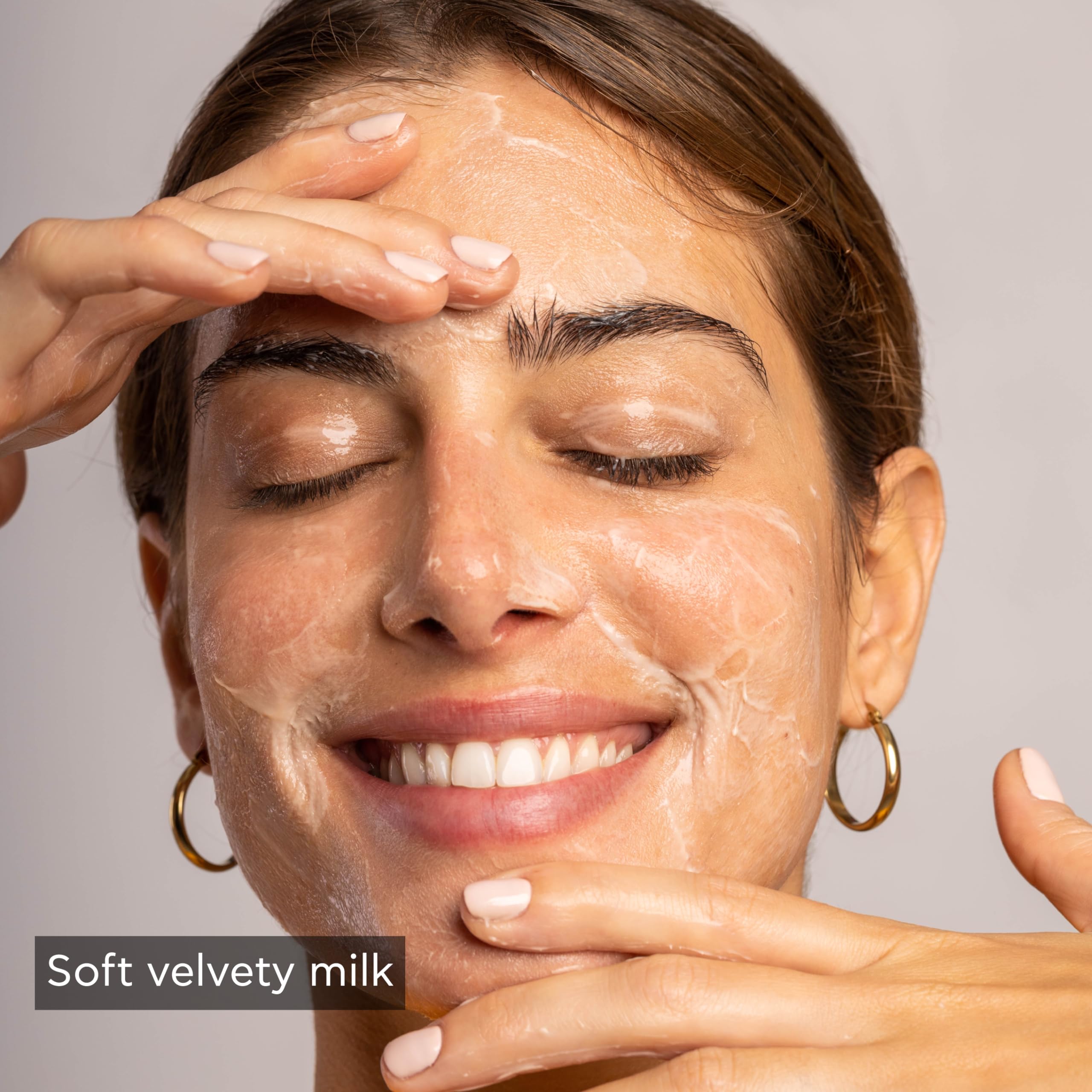 Apivita cleansing milk swatch on skin; tones softly while removing impurities.