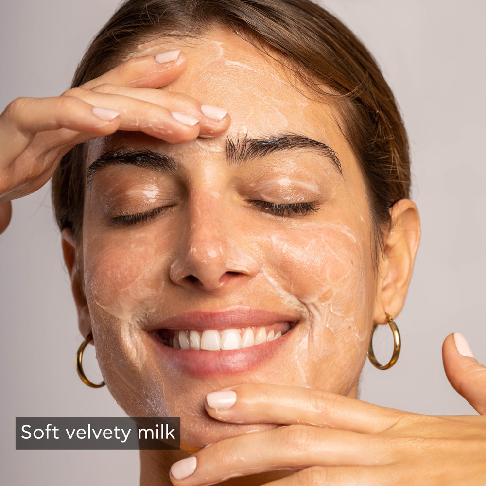 Apivita cleansing milk swatch on skin; tones softly while removing impurities.