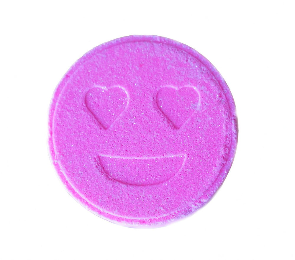 Aquaemoticonsllc Love It Bath Bomb showcases a pink heart-eyes design for a playful bath ritual.