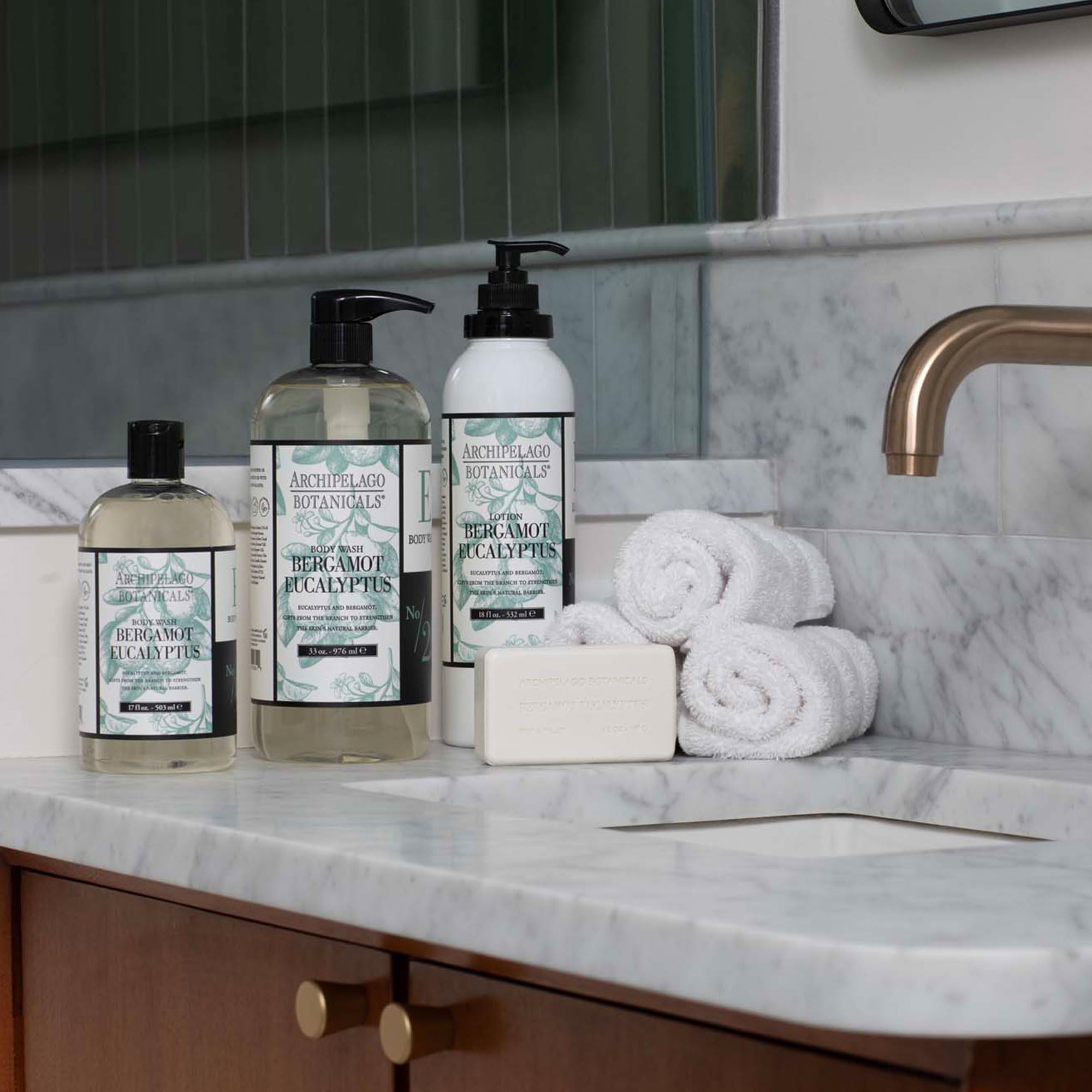 Archipelago Botanicals body wash with sponge creating rich lather for clean skin.