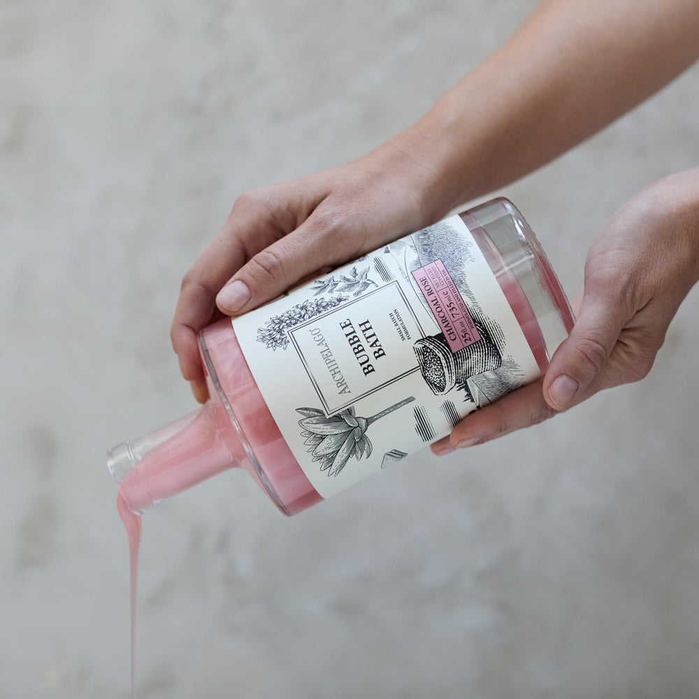 Archipelago Botanicals Charcoal Rose Bubble Bath close-up shows charcoal powder.