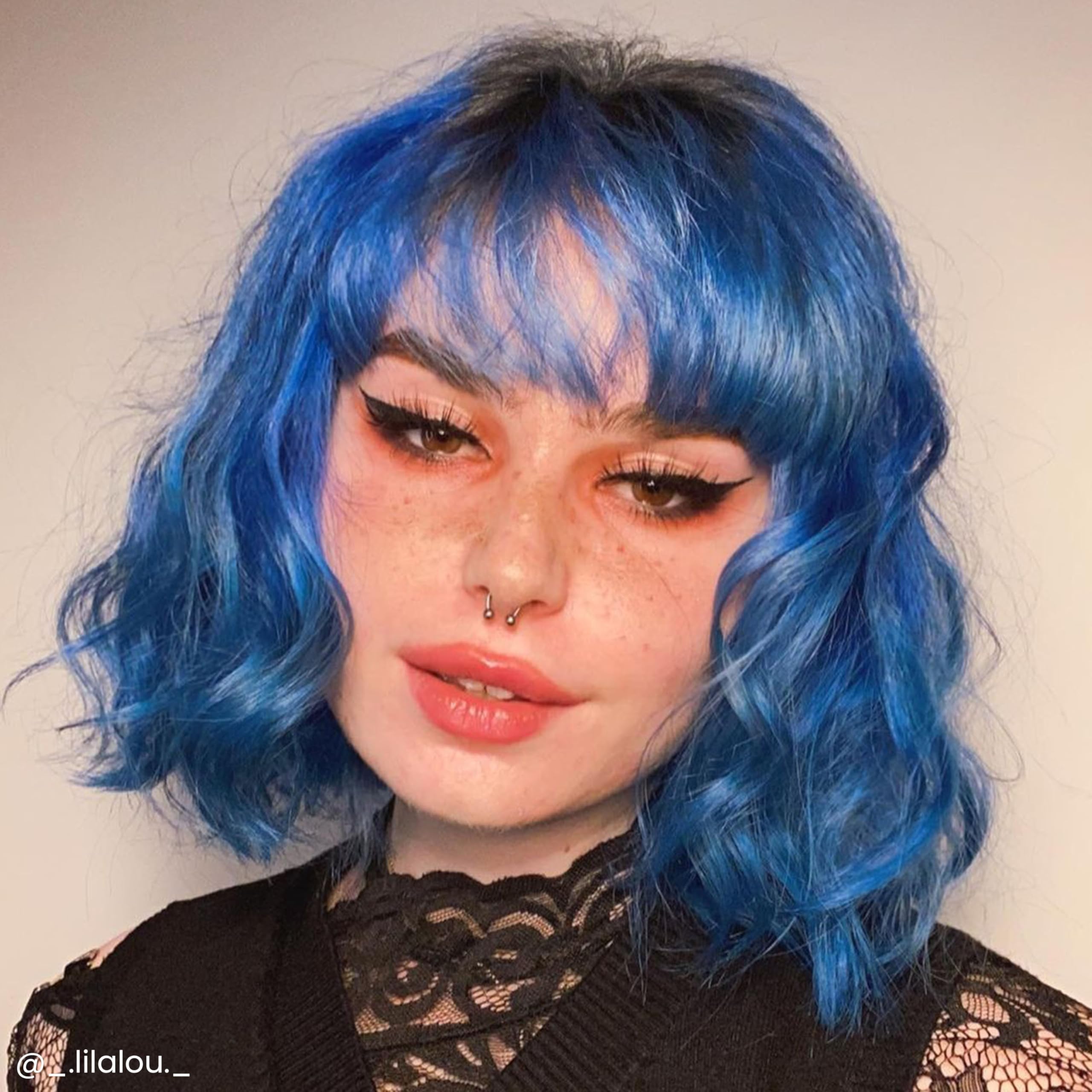 Applying Poseidon to hair to achieve even blue tone with conditioning formula.