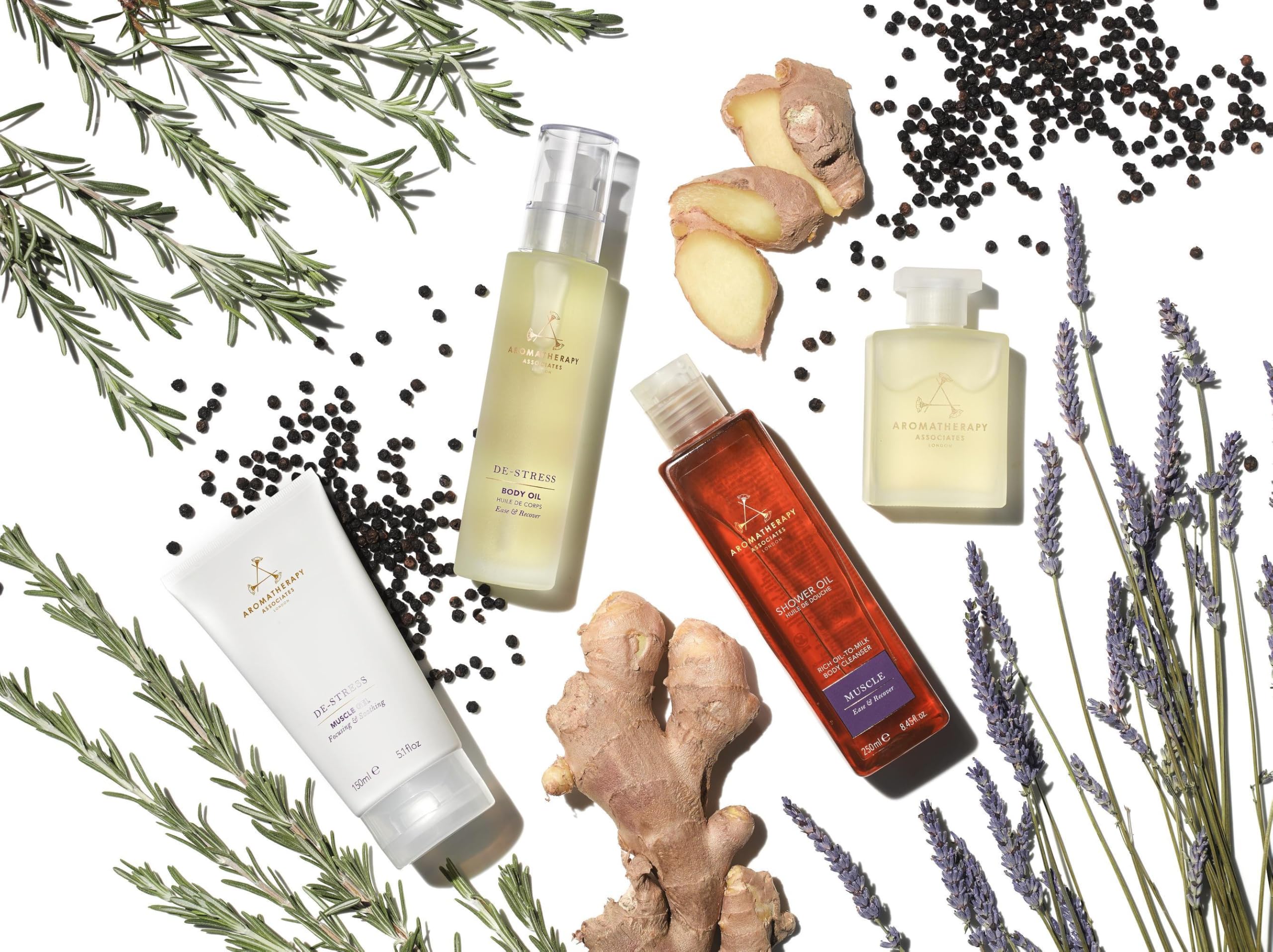 Aromatherapy Associates De-Stress Muscle Shower Oil on a bathroom shelf evokes spa ritual.