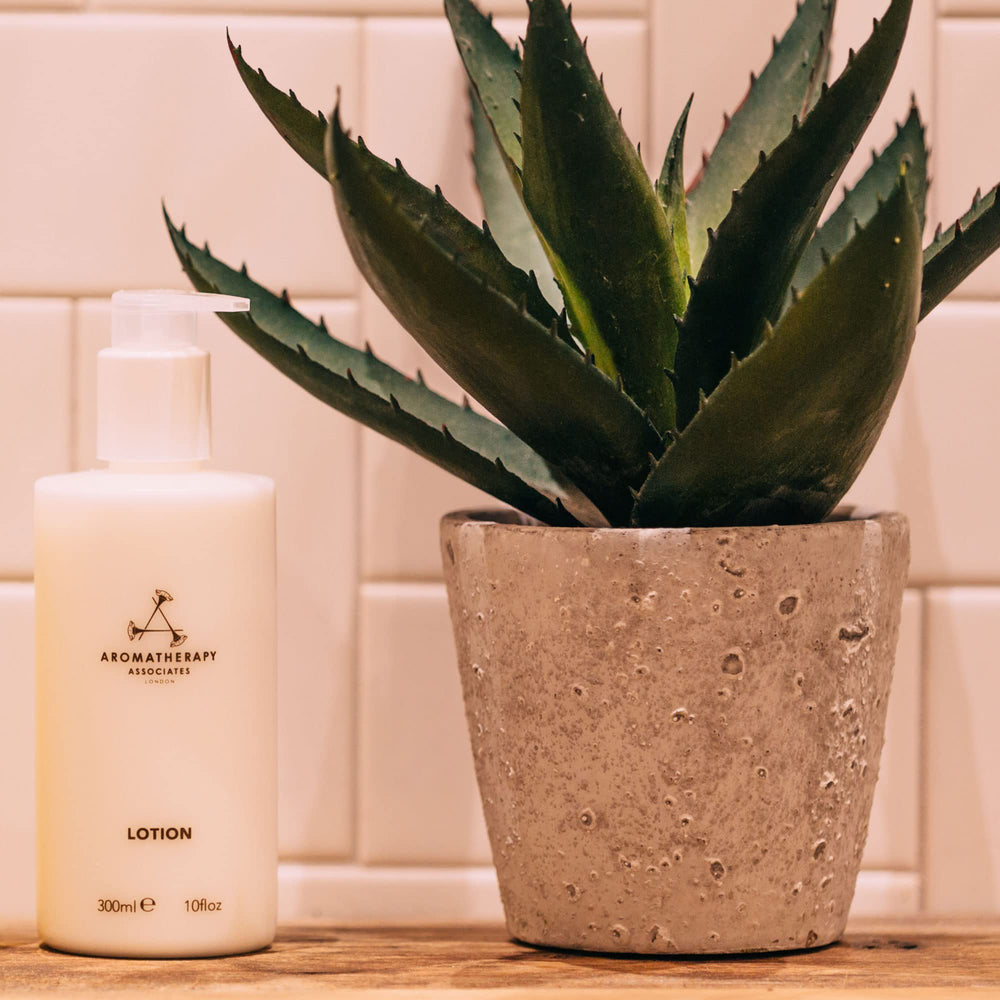 Aromatherapy Associates Hand and Body Lotion featuring ylang-ylang, geranium, and patchouli essential oils for uplifting calm