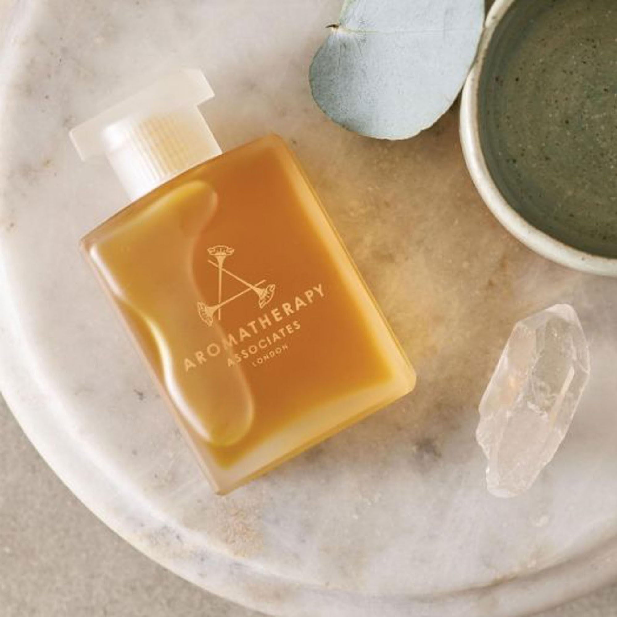 Aromatherapy Associates Revive Evening oil beside bath and diffuser for spa-like ritual