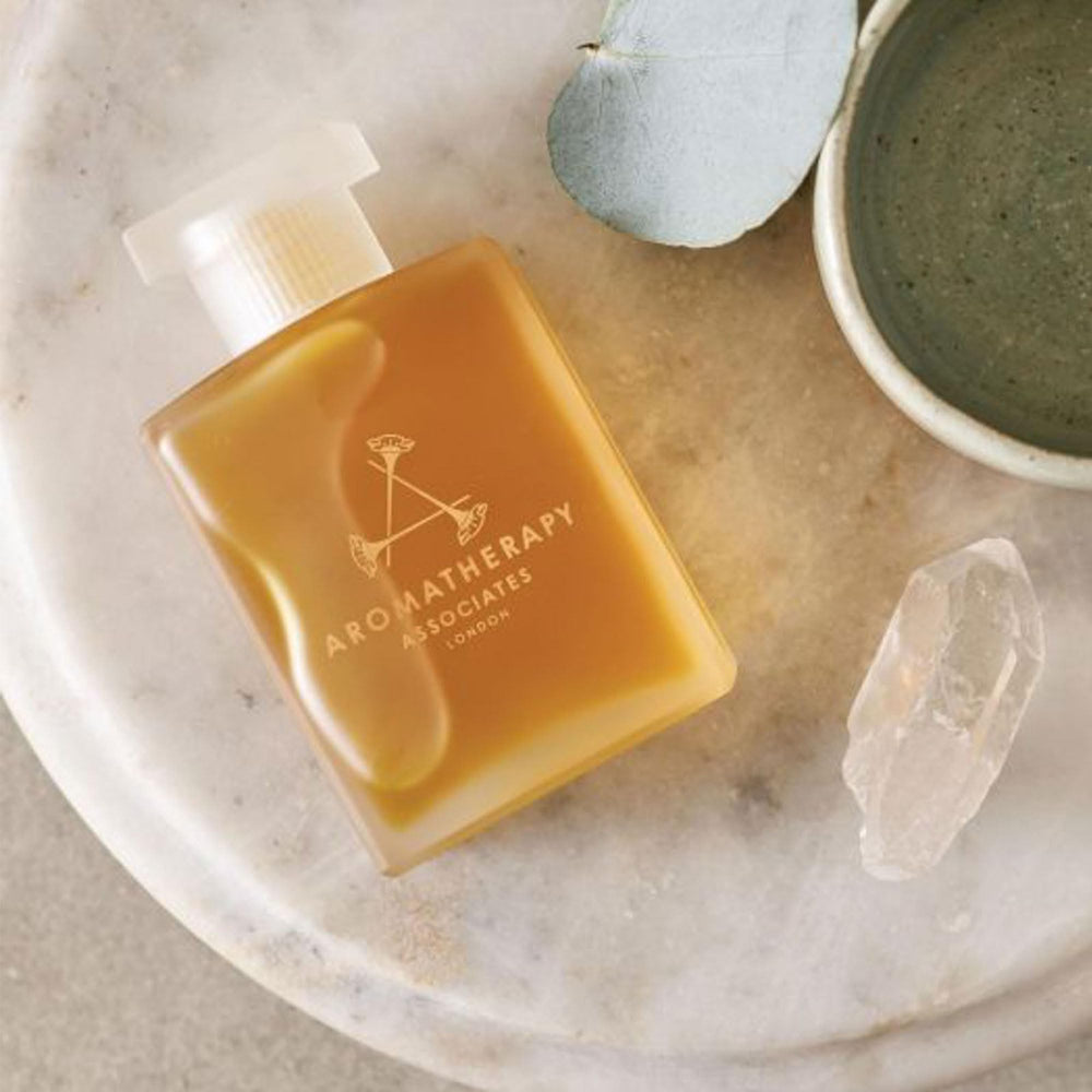 Aromatherapy Associates Revive Evening oil beside bath and diffuser for spa-like ritual