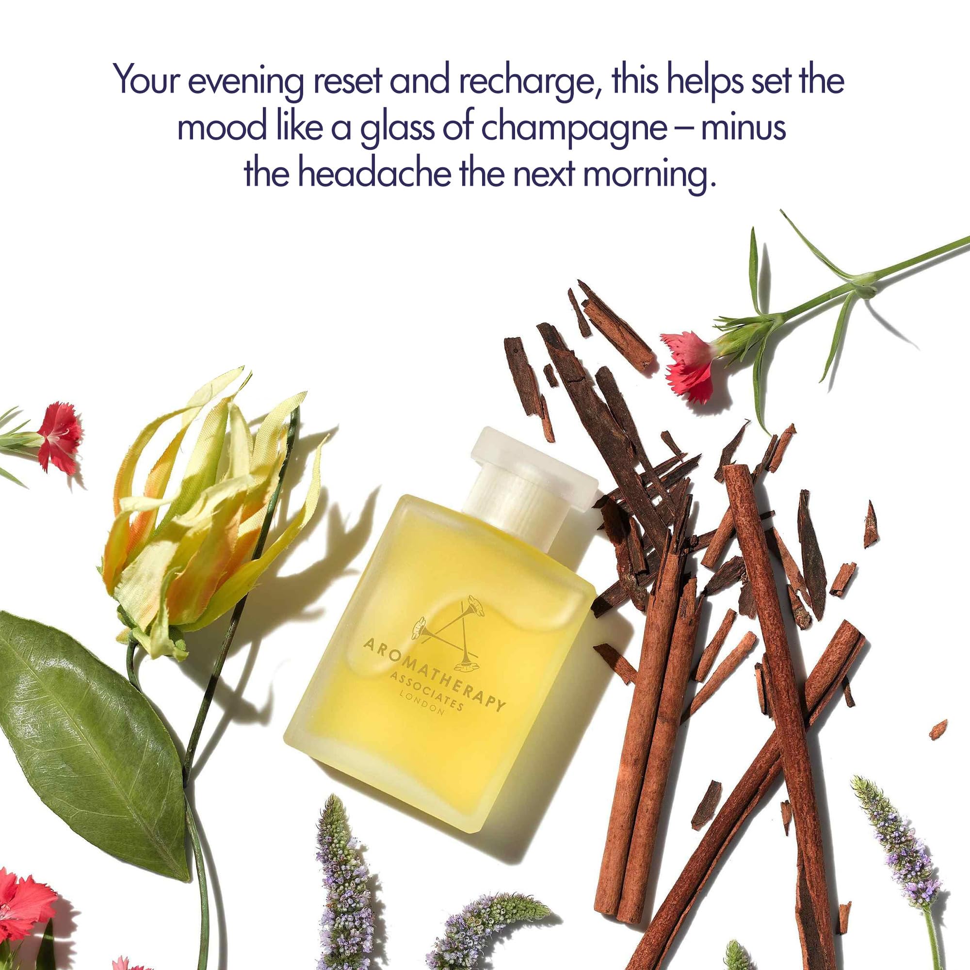 Aromatherapy Associates Revive Evening oil beside towels for a mood-refreshing shower