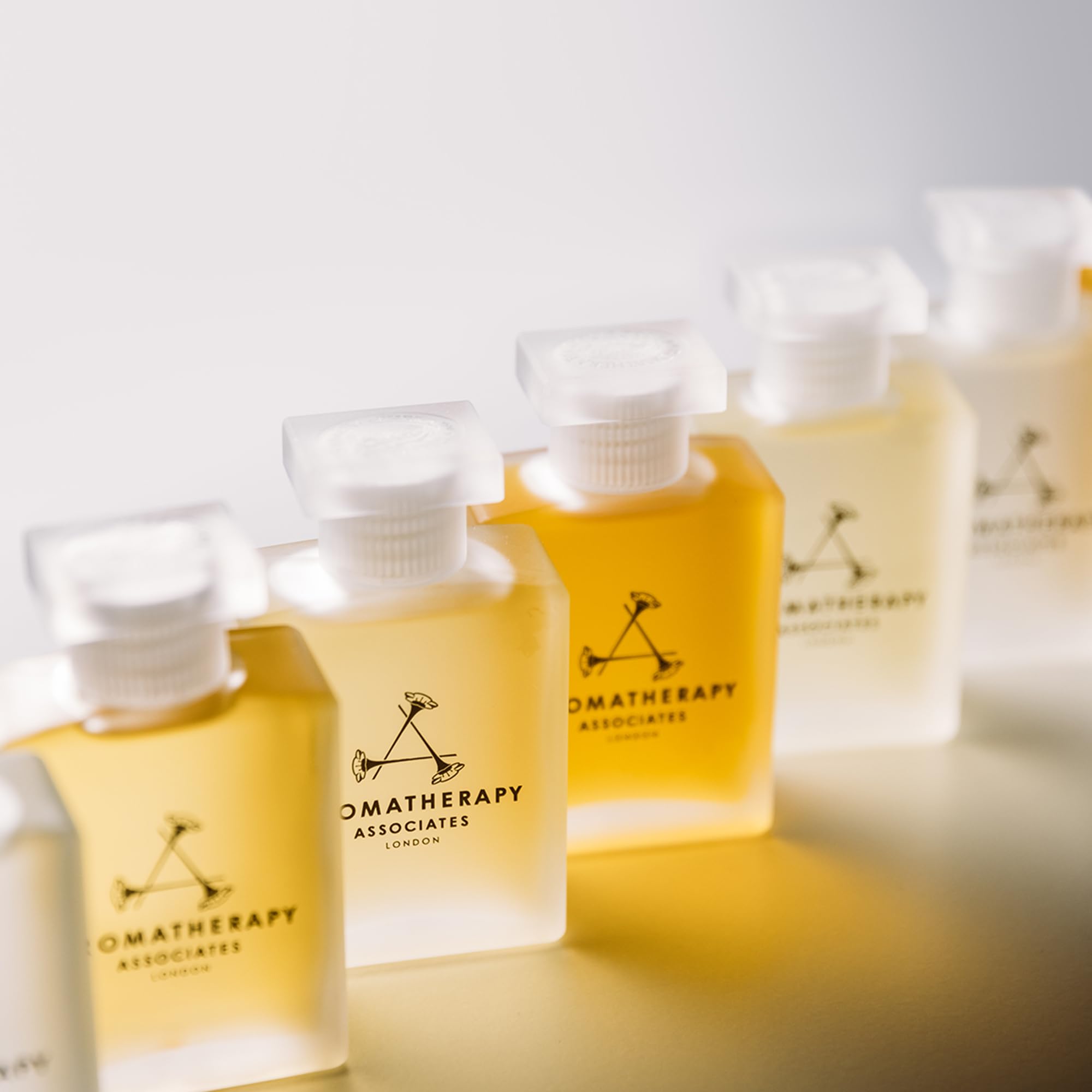 Aromatherapy Associates Revive Evening oil on a spa-inspired vanity with candlelight