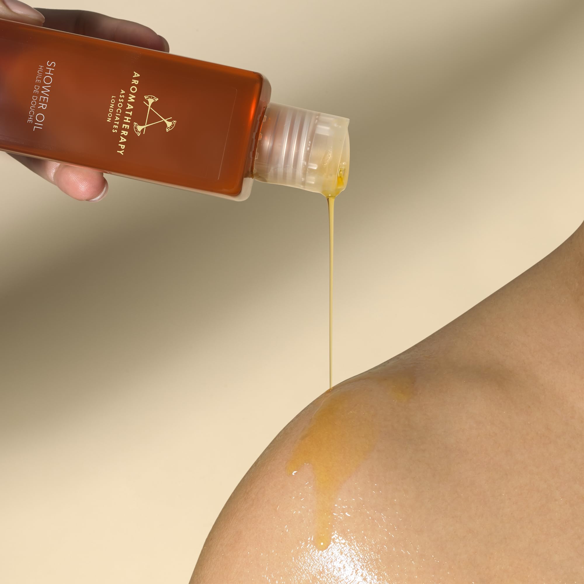 Aromatherapy Associates Rose Shower Oil in a bright shower setting.