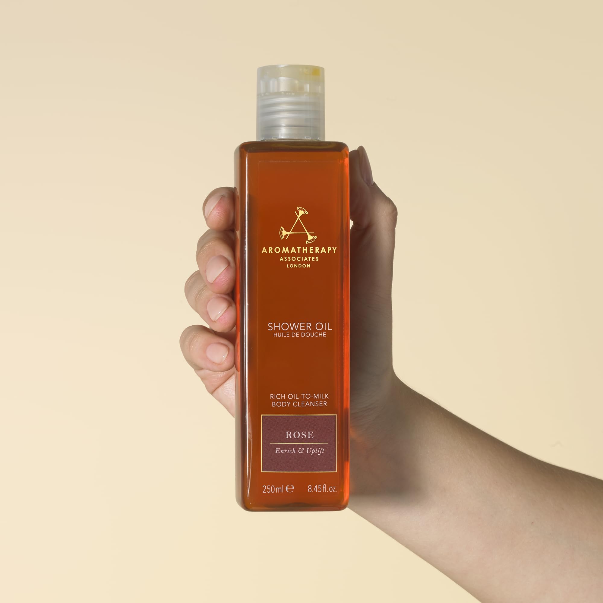 Aromatherapy Associates Rose Shower Oil during a shower scene with warm light.